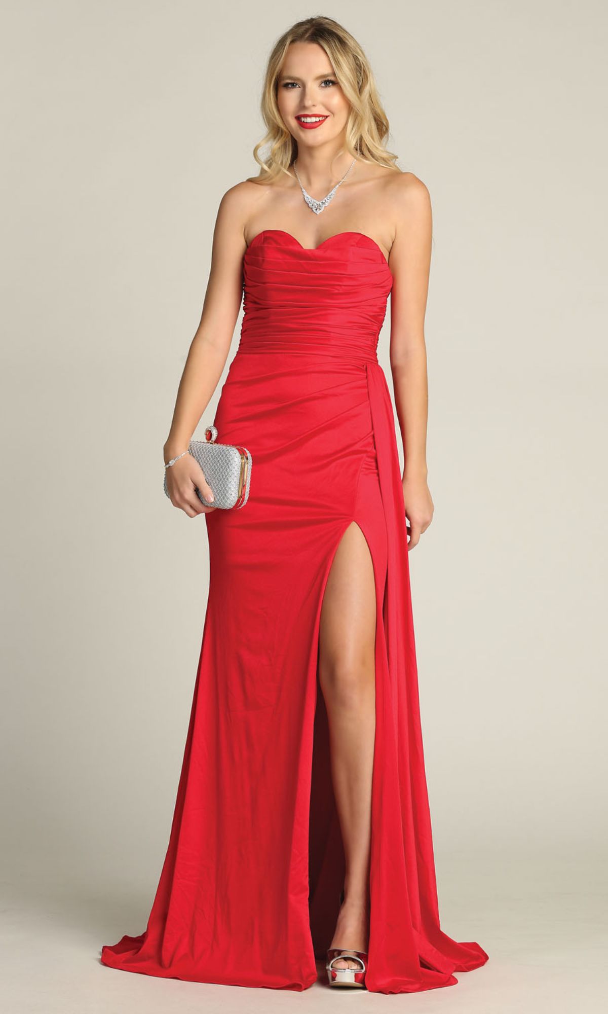 Woman in the Side-Sash Strapless Long Prom Dress: Chicas C327, featuring a sweetheart bodice and thigh-high slit, holding a silver clutch while standing against a plain background.